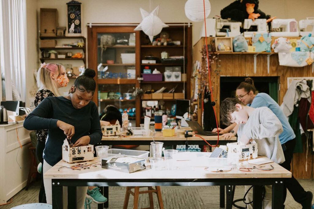 “students working on a project at a science classroom table at Provident Charter School West”