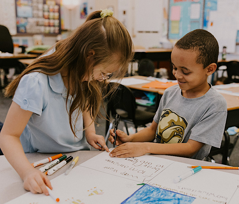 Two students working together on a school project.